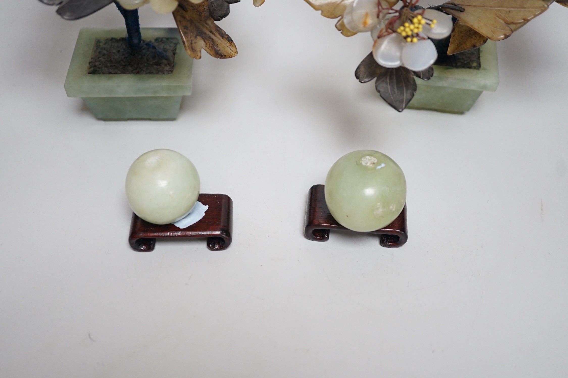 A pair of Chinese hardstone model trees and two model fruits, trees 21cms high